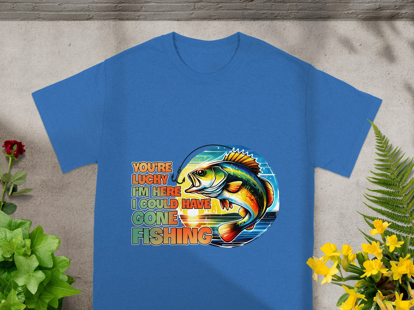 Blue t-shirt with colorful bass fishing graphic and text: "You're lucky I'm here, I could have gone fishing."