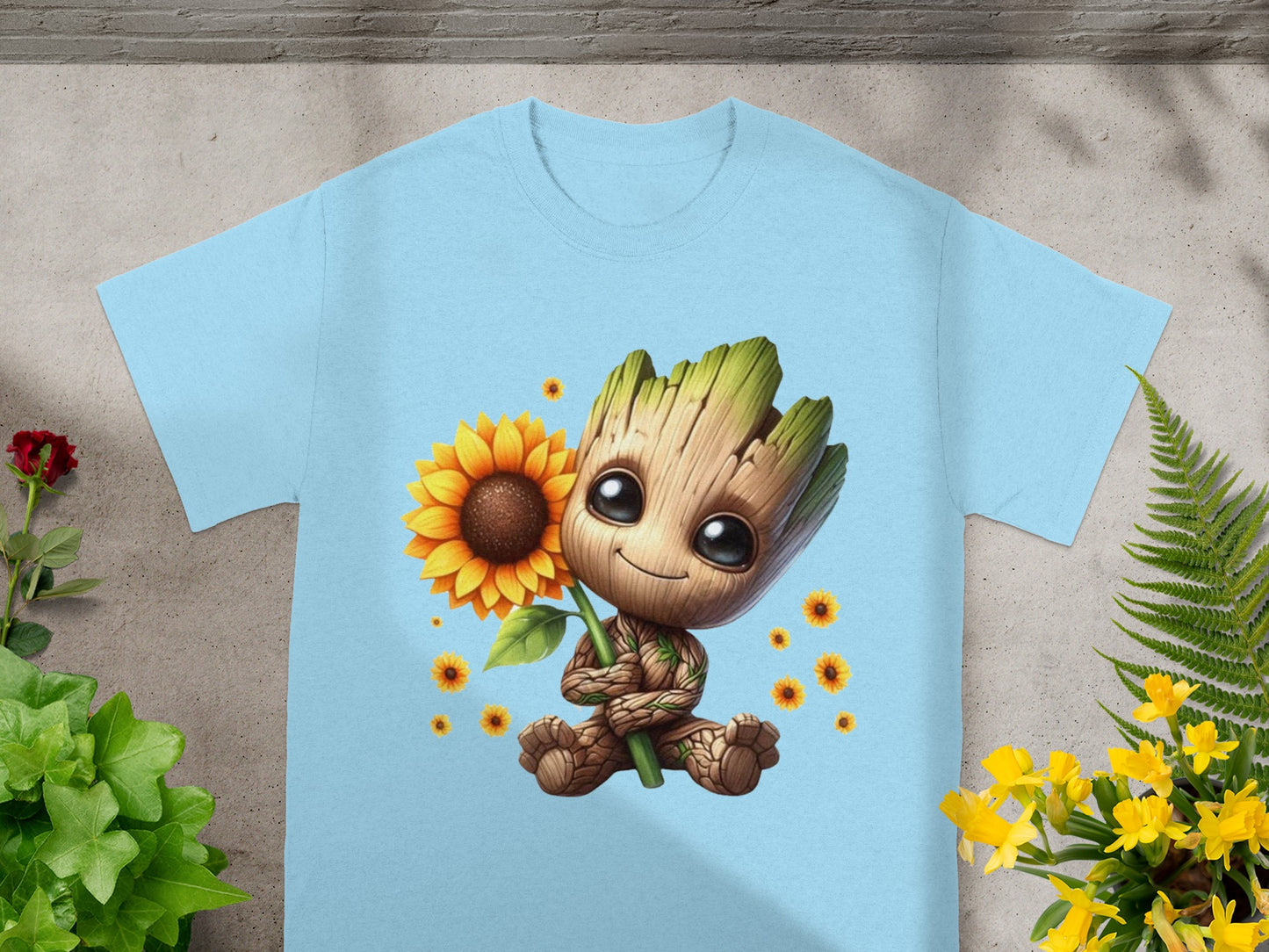 Baby Groot holding a sunflower on a light blue t-shirt.