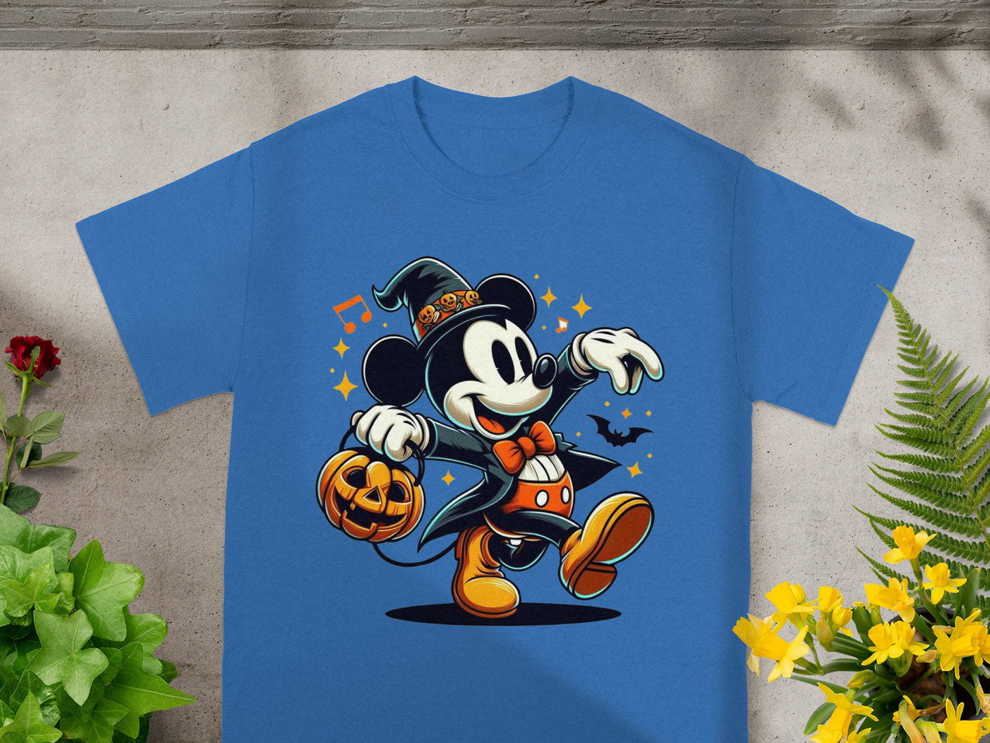 Mickey Mouse in Halloween costume holding a pumpkin candy bucket.