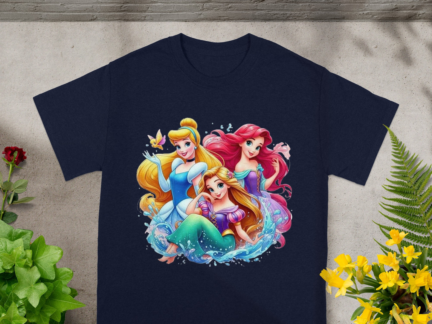Disney Princesses Ariel, Cinderella, and Rapunzel in colorful artwork on a navy t-shirt.