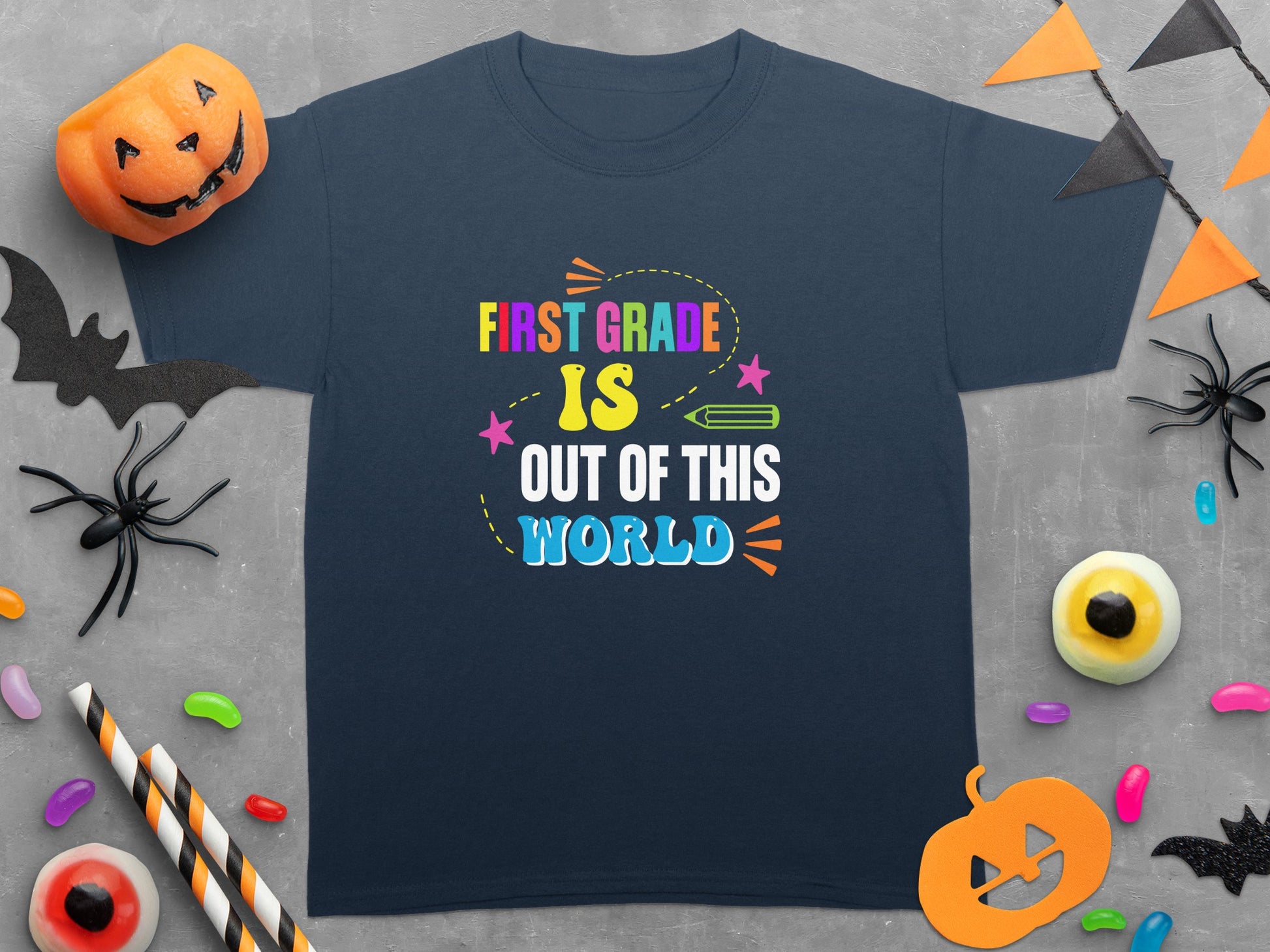 Navy t-shirt with "First Grade Is Out Of This World" text and Halloween decorations.