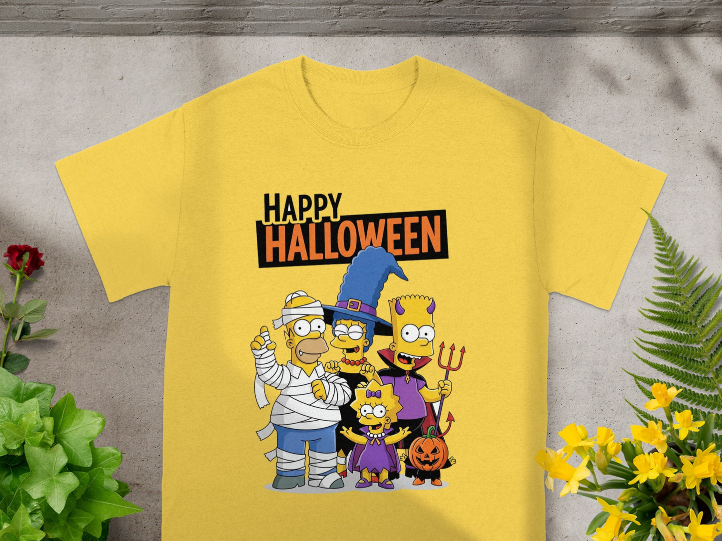The Simpsons family in Halloween costumes with "Happy Halloween" text on a yellow t-shirt.