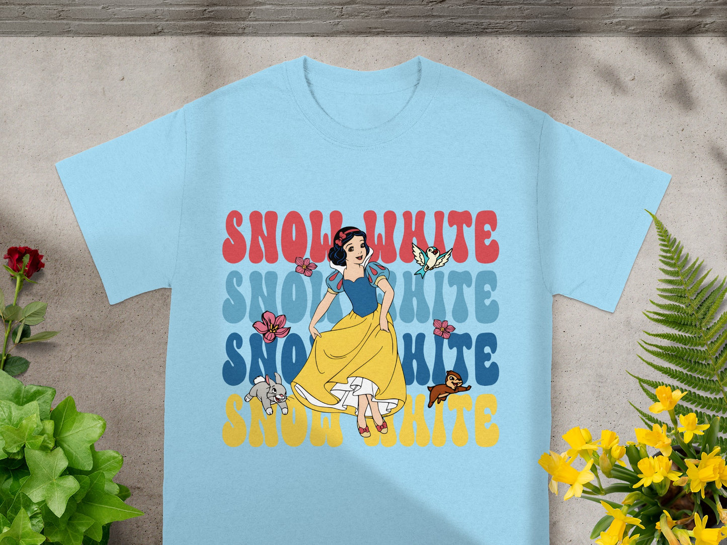 Light blue t-shirt with "Snow White" text and character art.