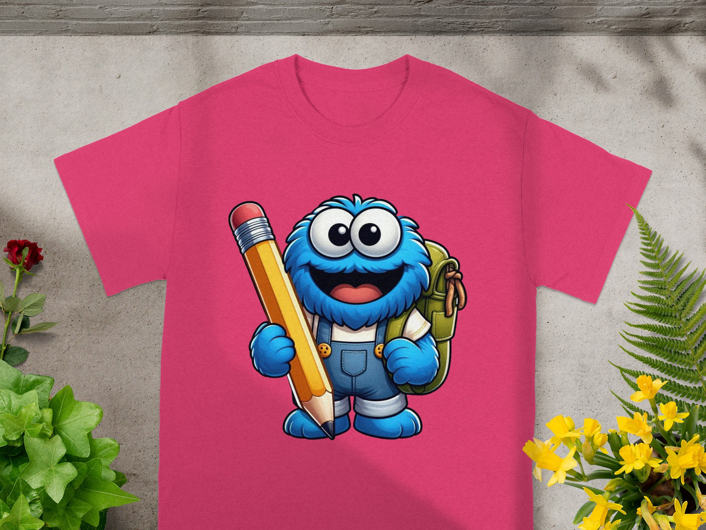 Fuchsia t-shirt featuring Cookie Monster holding a large yellow pencil and backpack.