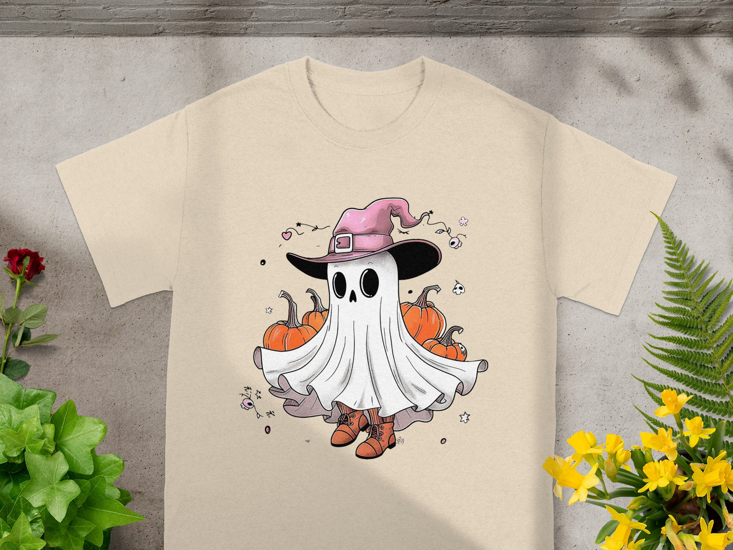 Ghost wearing a pink witch hat surrounded by pumpkins and Halloween-themed elements.