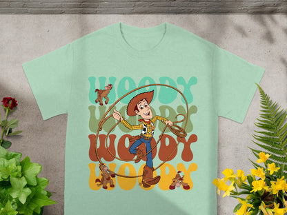 Woody from Toy Story with rope and toy horses on a light green t-shirt.