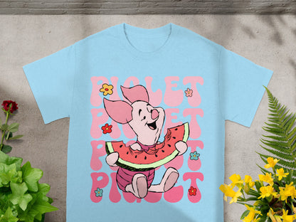 Piglet eating watermelon with "Piglet" text on a light blue t-shirt.