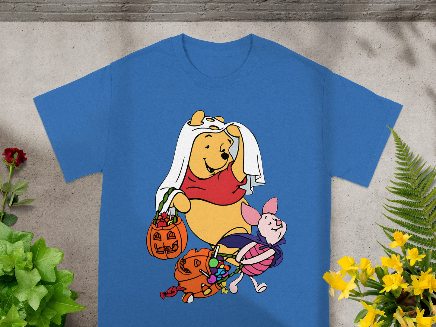 Winnie the Pooh and Piglet in Halloween costumes with candy.