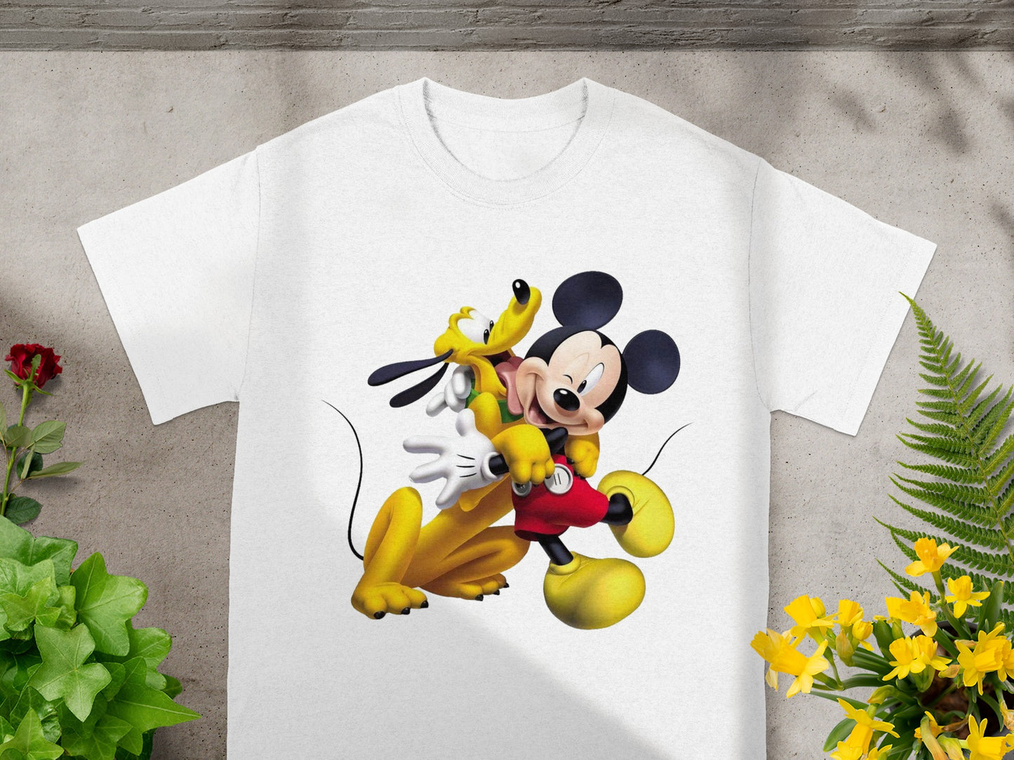 White t-shirt featuring Mickey Mouse and Pluto embracing.