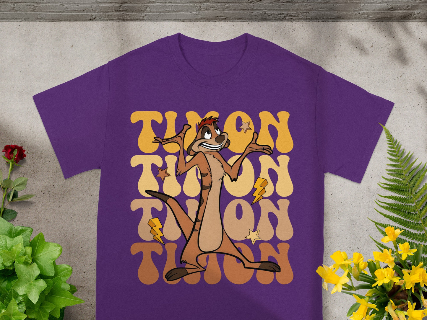 Purple t-shirt with a cartoon meerkat and "Timon" text.