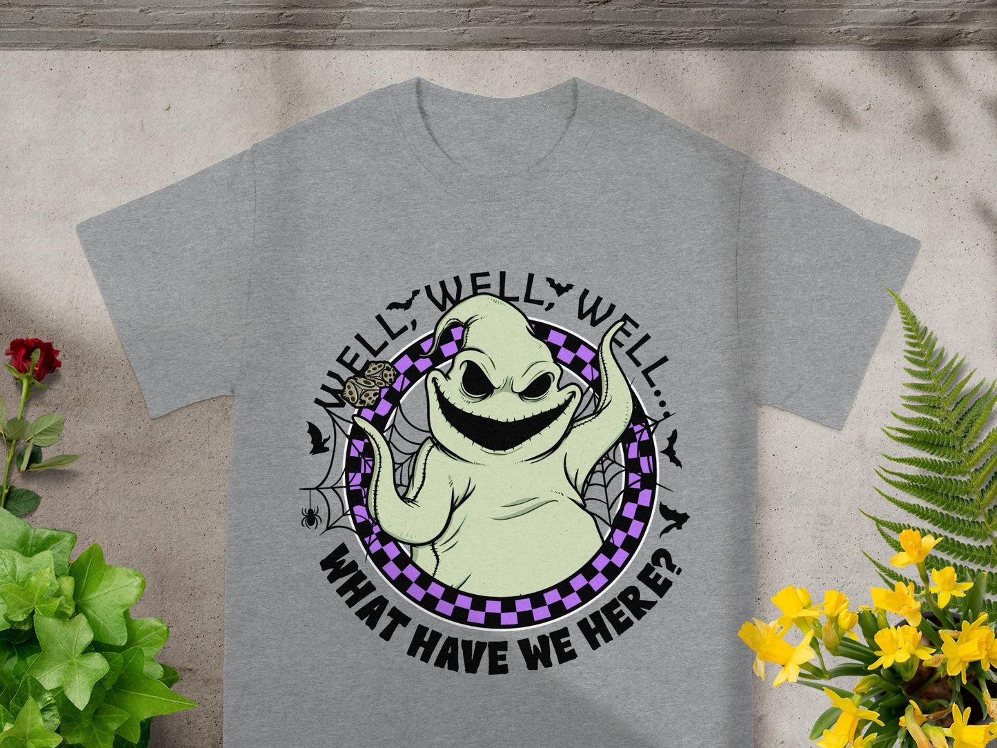 Grey t-shirt with a cartoon ghost on it saying "Well, well, well... What have we here?".