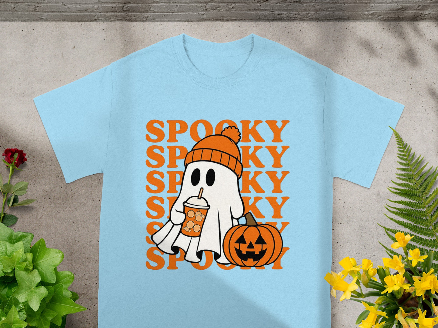 Light blue t-shirt with a Halloween graphic featuring a ghost with a drink and a pumpkin.