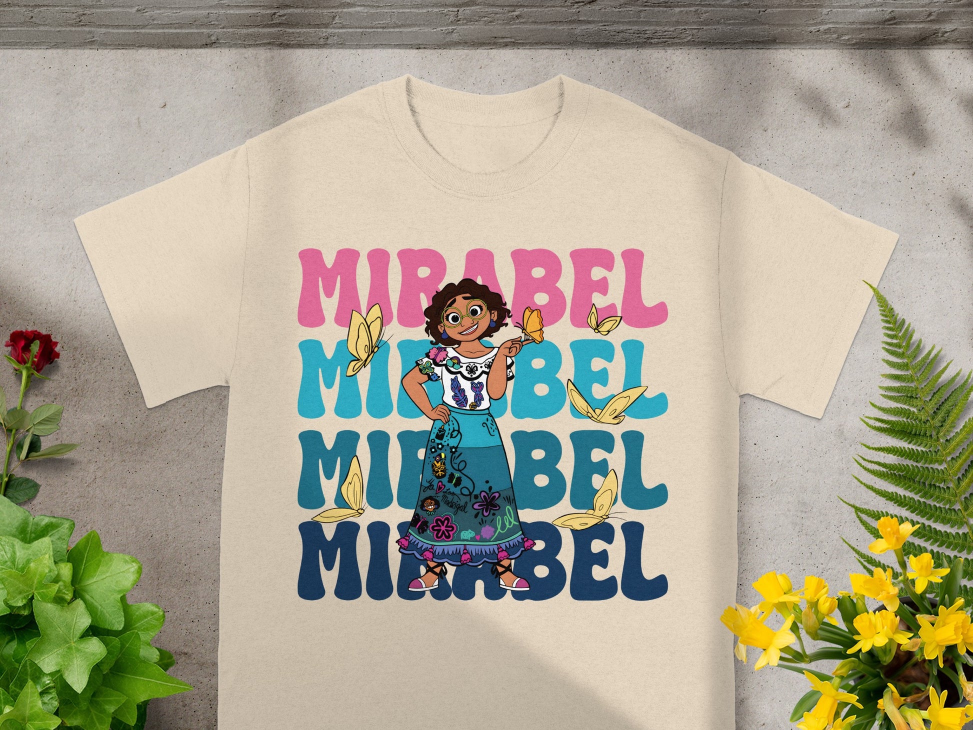 Mirabel from Encanto with butterflies, text reads "MIRABEL" in large letters.
