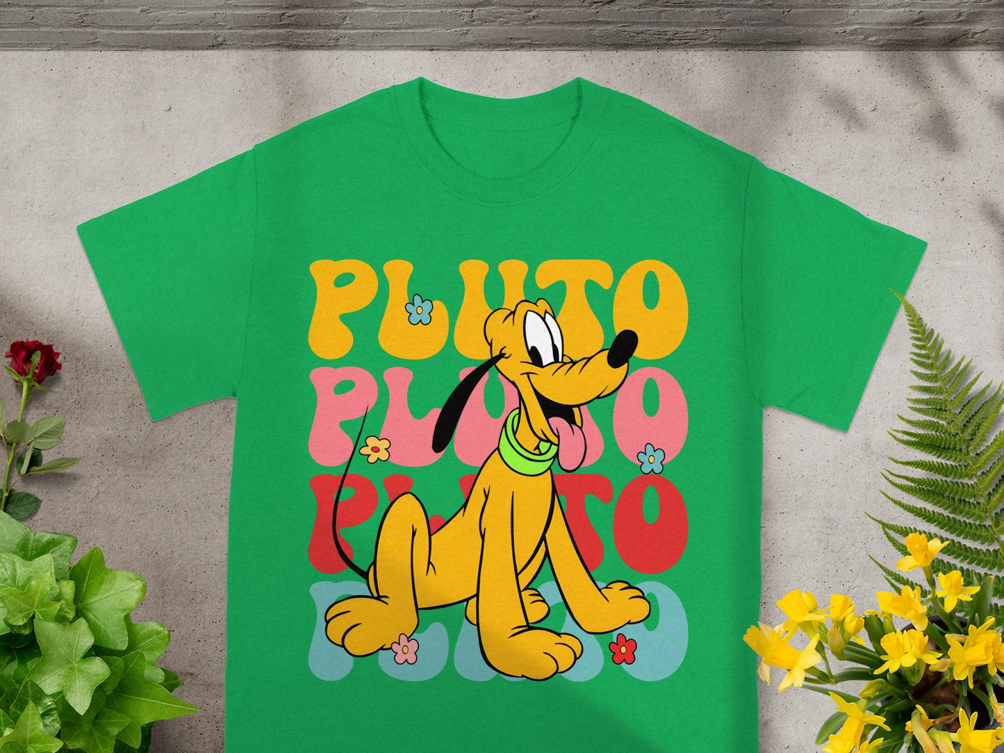 Green t-shirt with Pluto character and colorful "PLUTO" text.