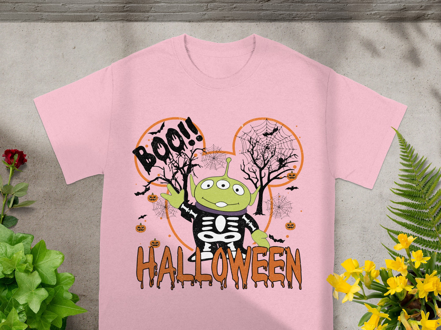 Pink t-shirt with Toy Story alien in skeleton costume and Halloween text.