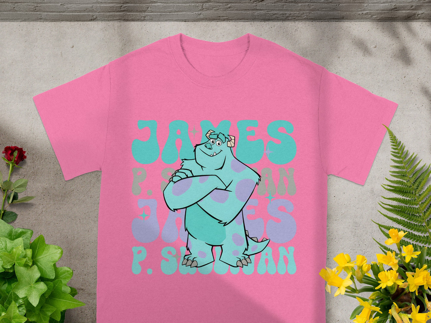 Monsters Inc. character Sulley on a pink t-shirt with "JAMES P. SULLIVAN" text.