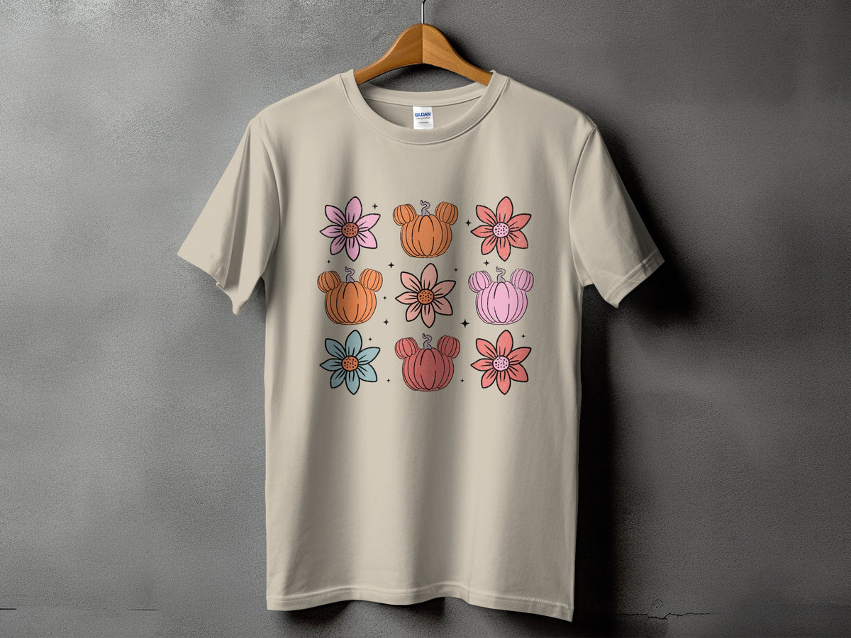 Light tan t-shirt with a repeating pattern of pastel-colored flowers and Mickey-shaped pumpkins.