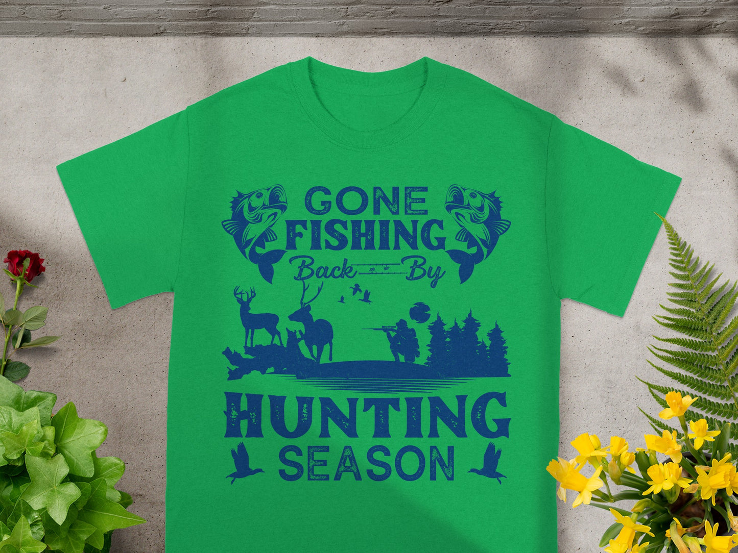 Green t-shirt with "Gone Fishing Back By Hunting Season" text and outdoor graphics.