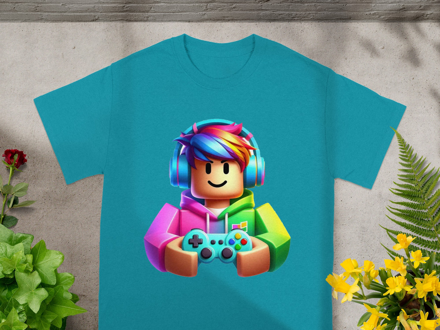 Turquoise t-shirt with cartoon gamer character wearing headphones and holding a controller.