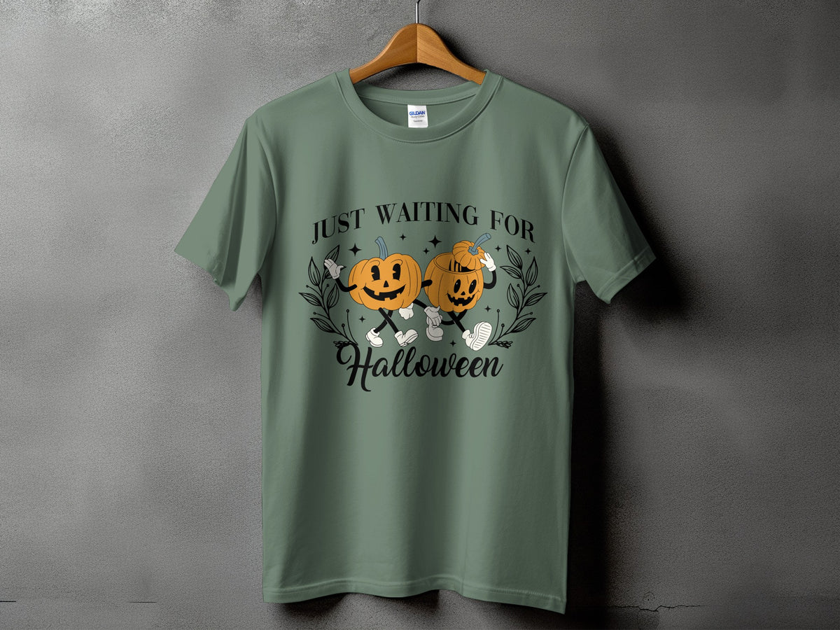 Green t-shirt with pumpkins saying "Just Waiting For Halloween".