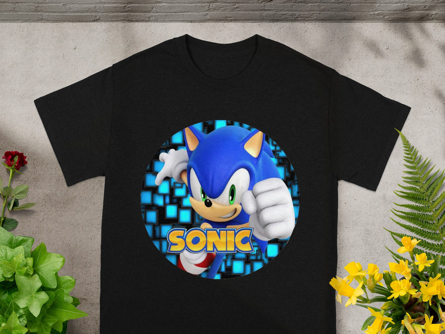 Black t-shirt with a circular graphic of Sonic the Hedgehog in front of blue squares.