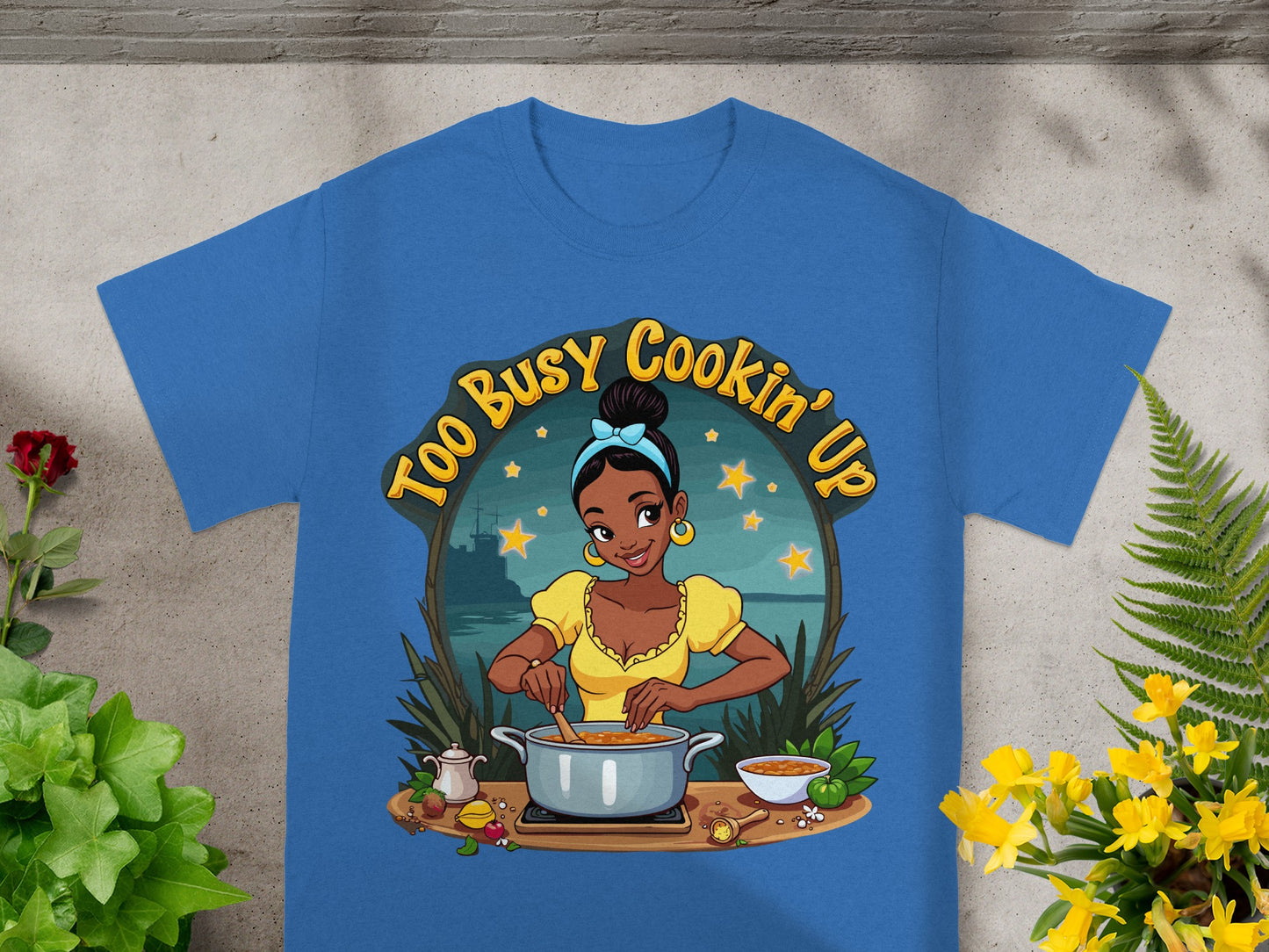 T-shirt graphic: Woman cooking with "Too Busy Cookin' Up" text.
