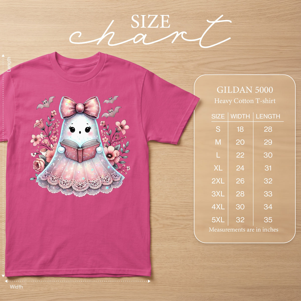 Pink t-shirt with a cute ghost graphic reading a book, surrounded by flowers and bats. Size chart included.