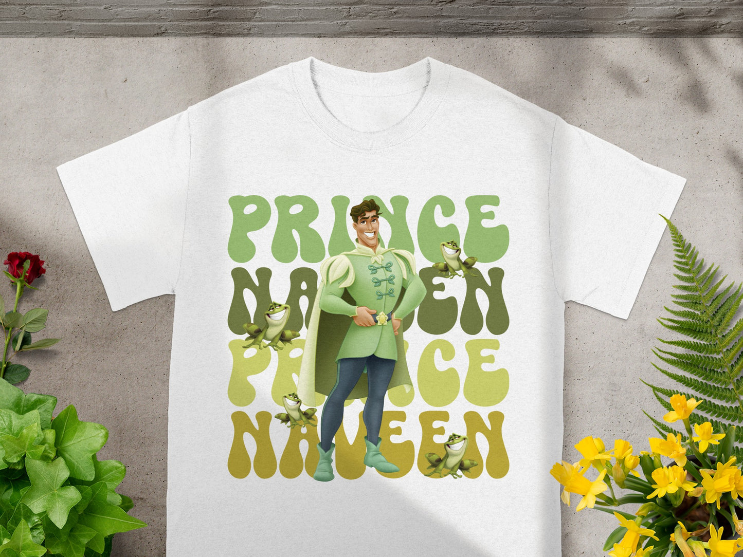 White t-shirt with "Prince" and "Nineteen" in groovy font, featuring a cartoon prince and frogs.