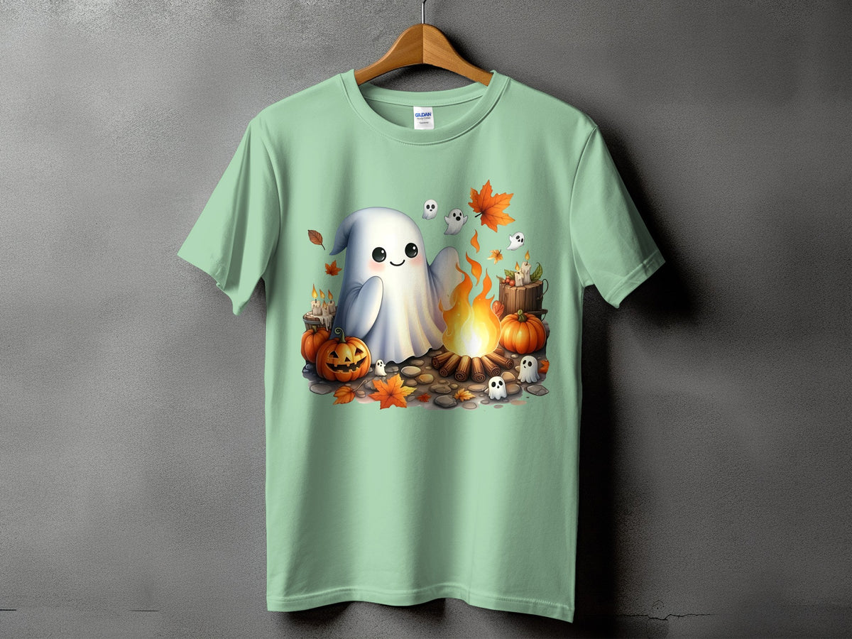 Light green t-shirt with a Halloween graphic of a ghost by a campfire.