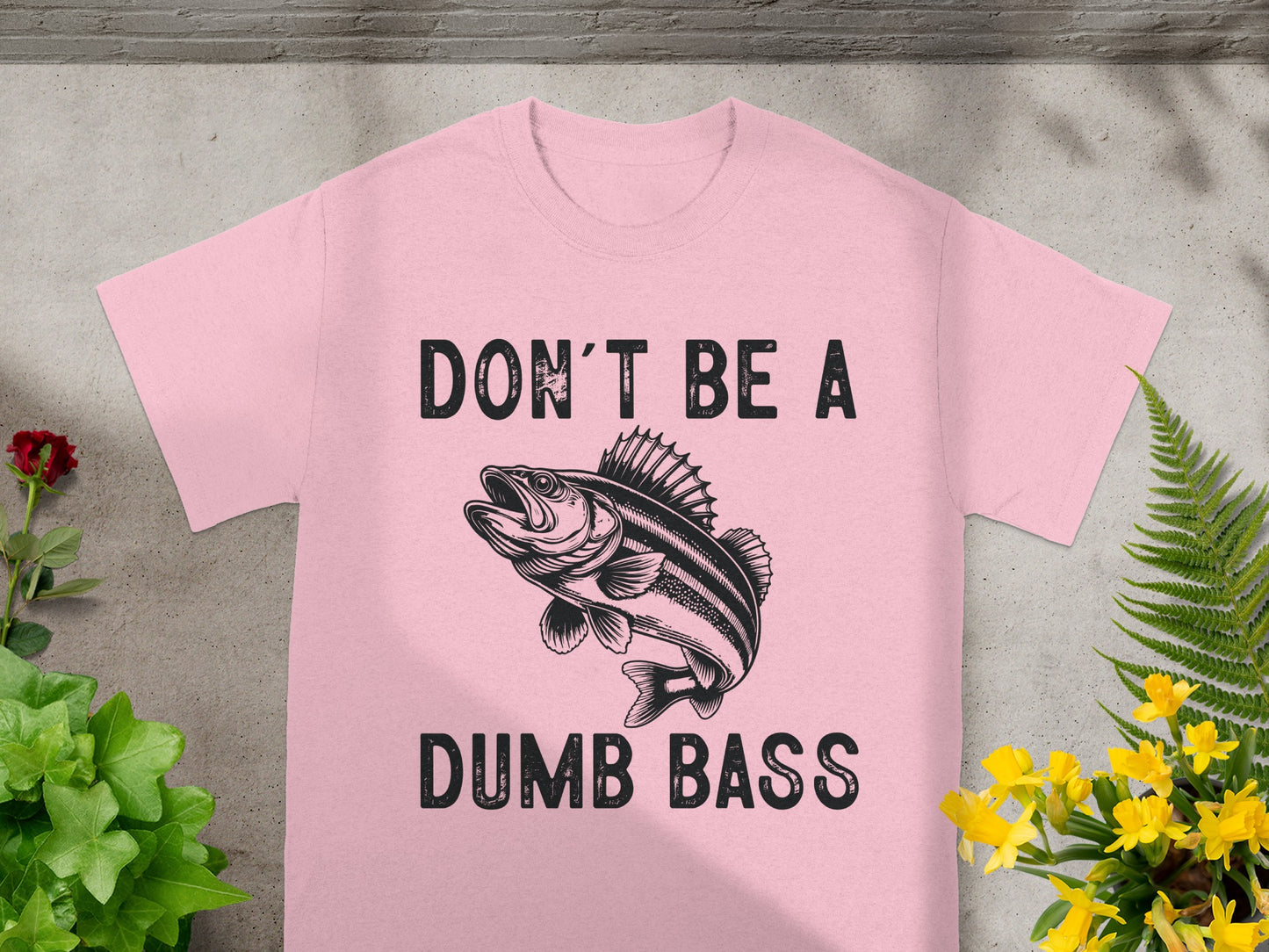 Pink t-shirt with "DON'T BE A DUMB BASS" and a fish graphic.