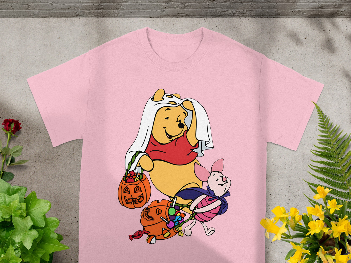 Winnie the Pooh and Piglet in Halloween costumes with candy.