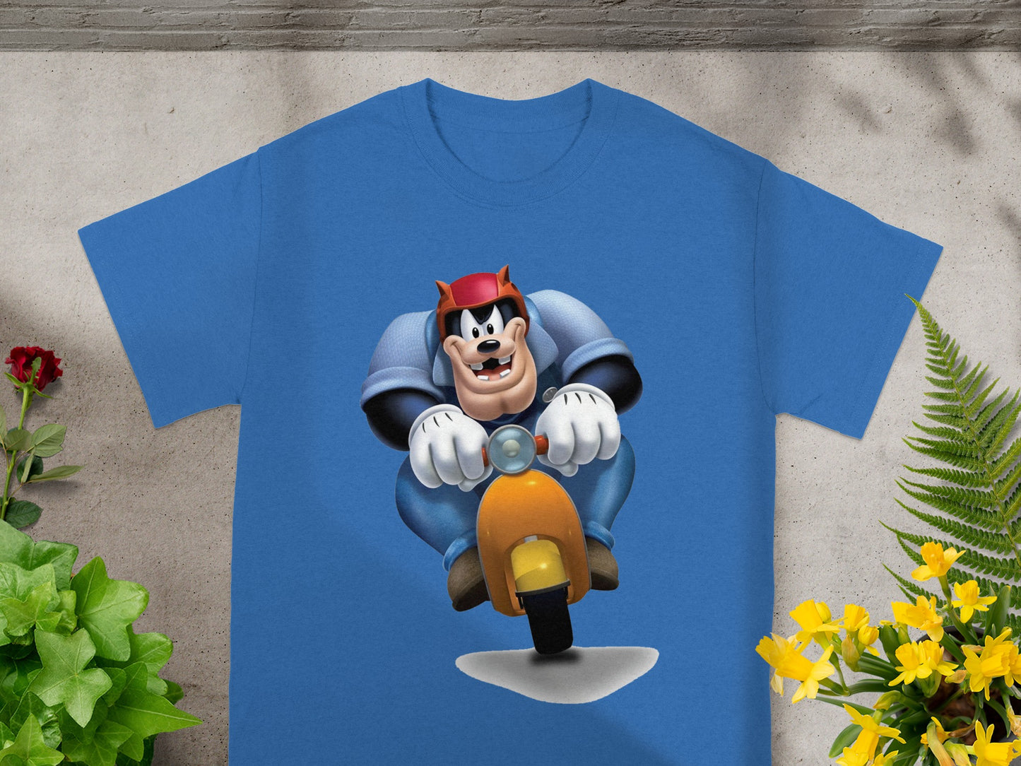 Blue t-shirt with cartoon character riding an orange scooter.