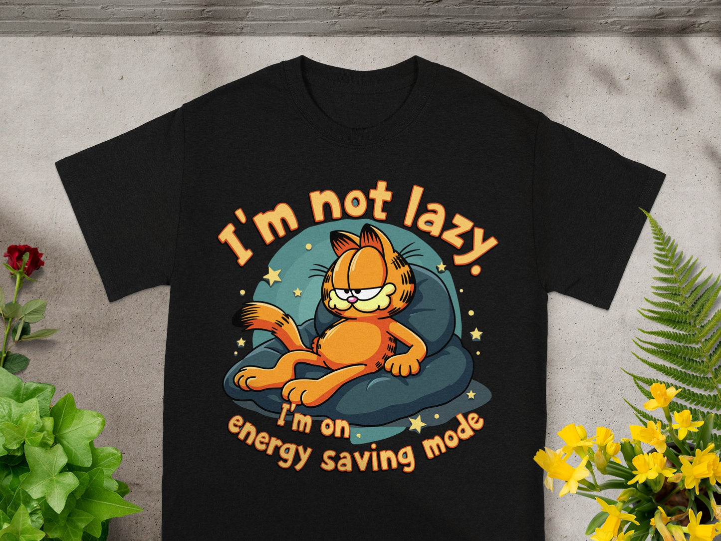 Black t-shirt with Garfield lying on a pillow saying "I'm not lazy. I'm on energy saving mode."