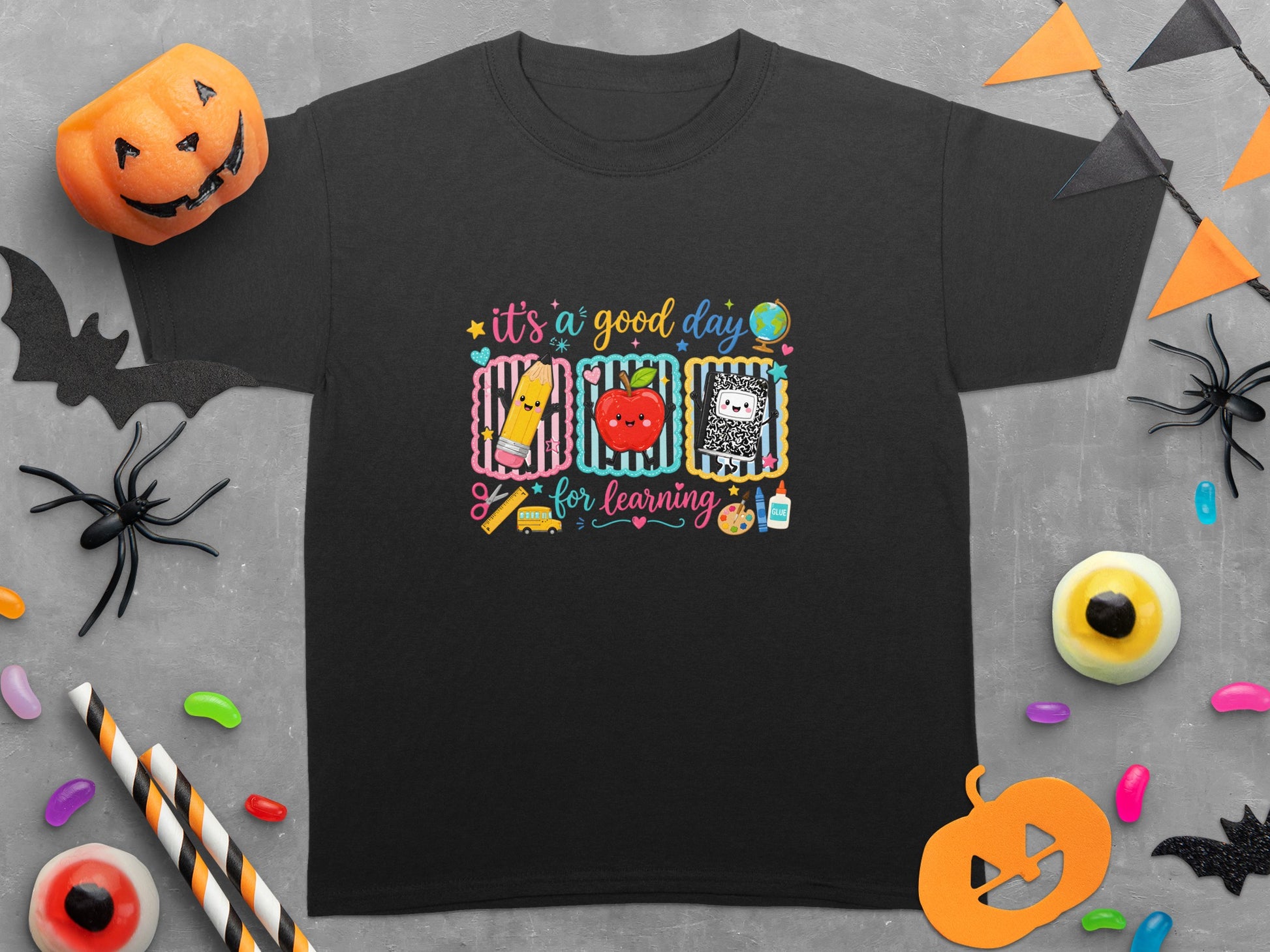 Black t-shirt with "it's a good day for learning" and school supplies art.