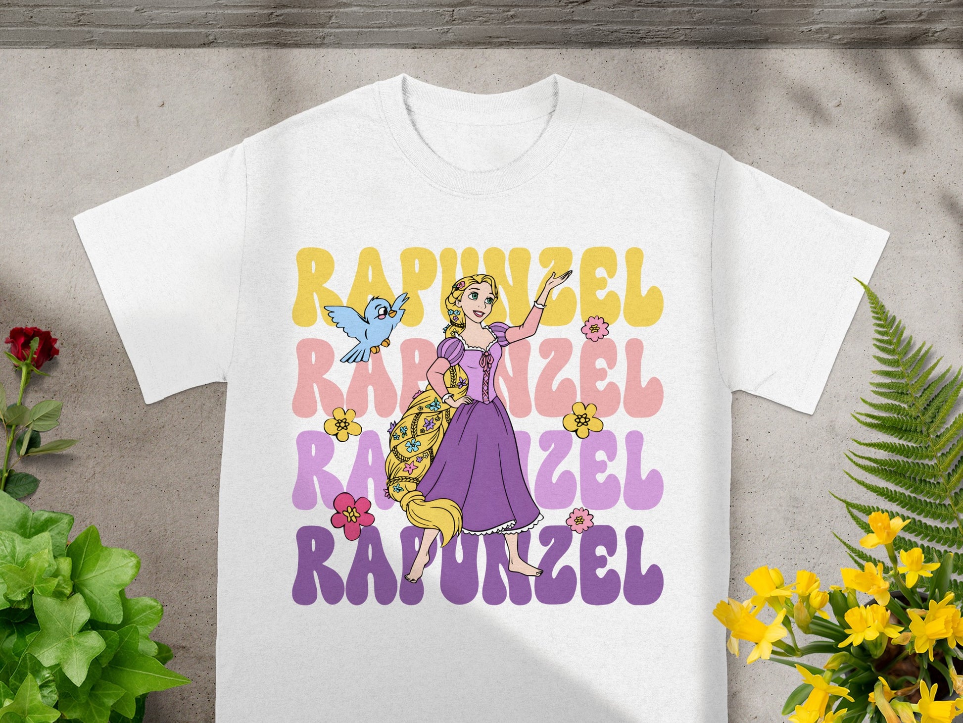 Rapunzel and Pascal on a white t-shirt with colorful lettering.