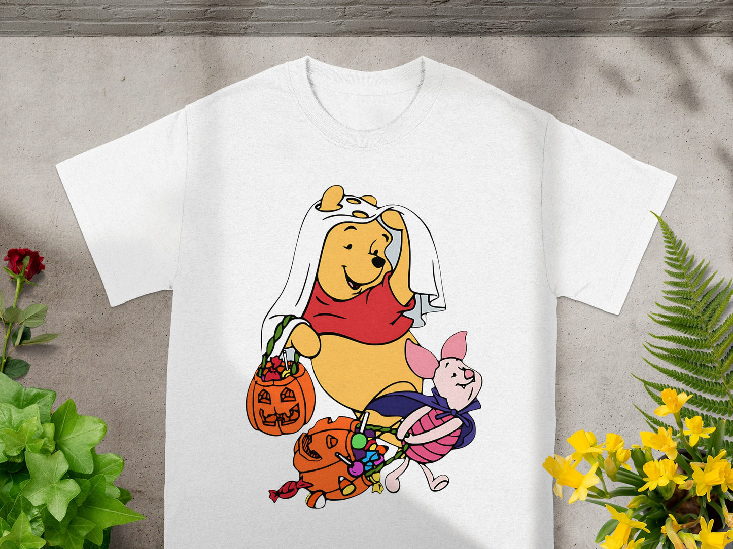 Winnie the Pooh and Piglet in Halloween costumes with candy and pumpkins.