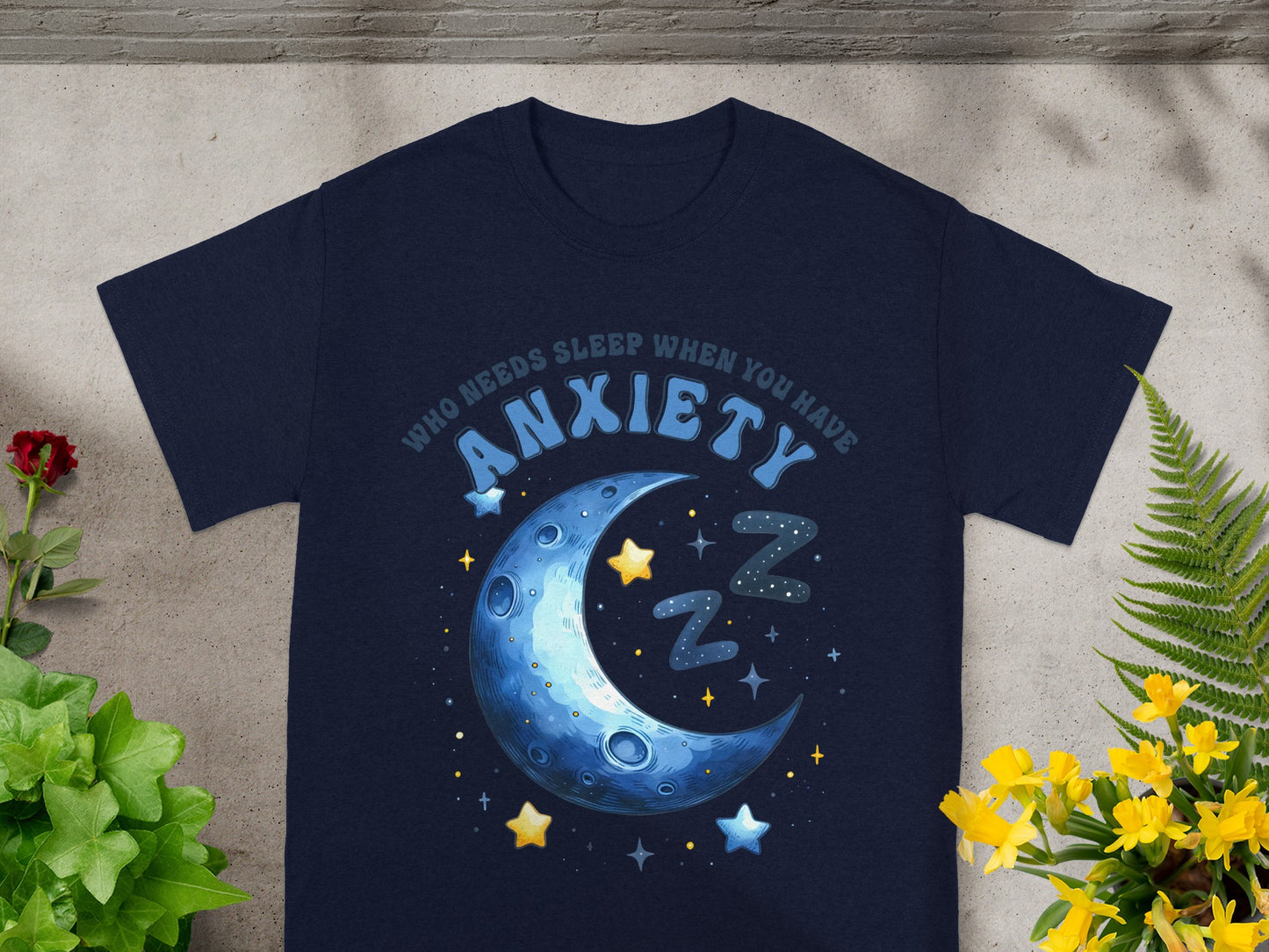 Navy t-shirt with a crescent moon, stars, and "Who needs sleep when you have anxiety" text.
