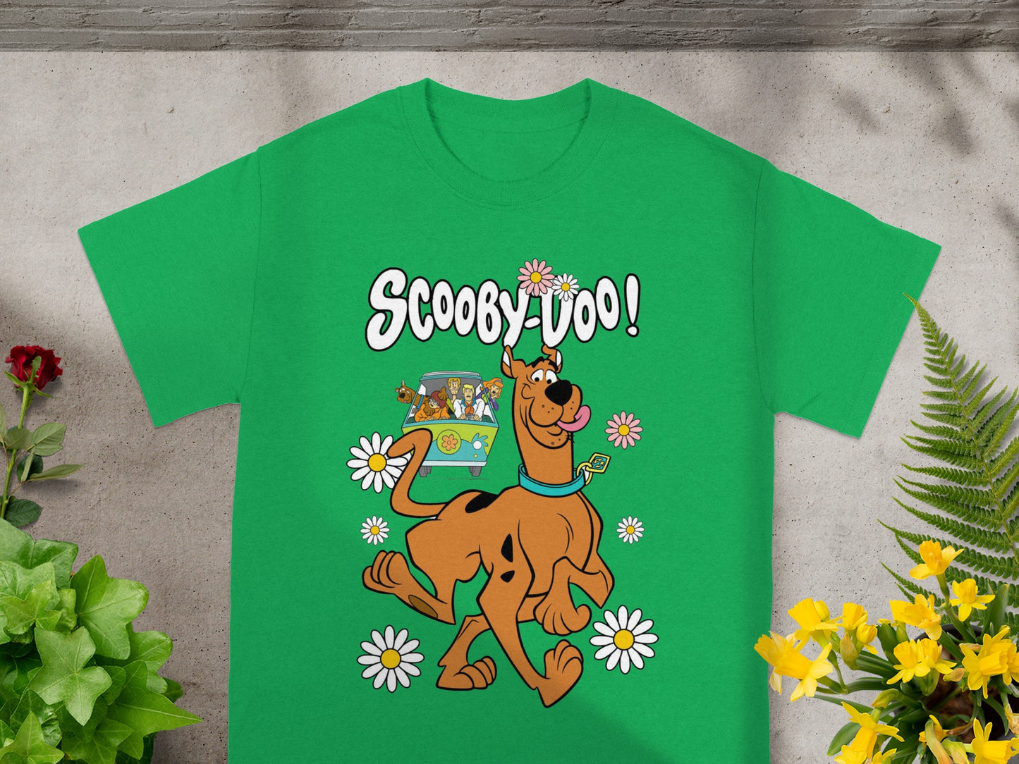 Green t-shirt with Scooby-Doo characters and flowers and "Scooby-Doo!" text.