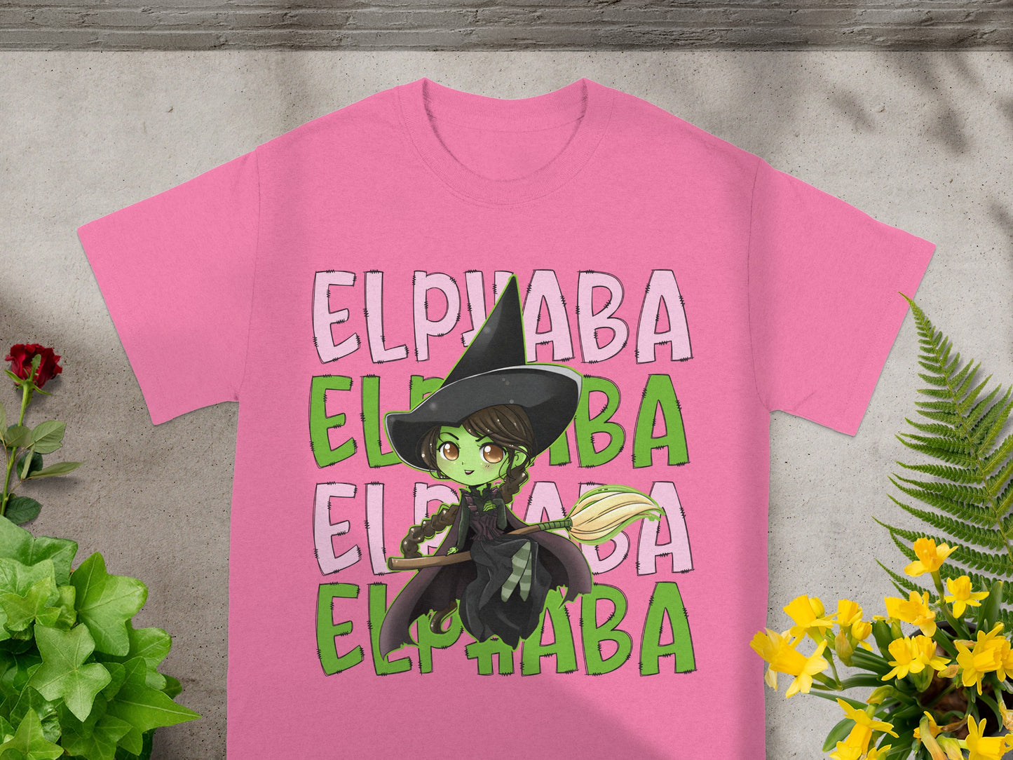 Pink t-shirt with green and pink Elphaba text and witch graphic.