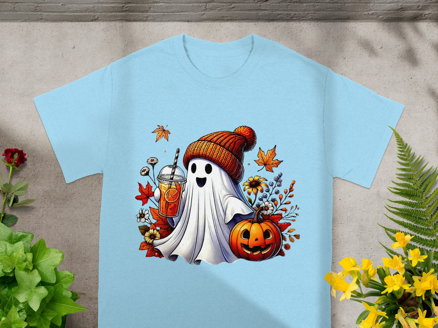 Ghost wearing beanie holding drink with pumpkin and fall leaves.