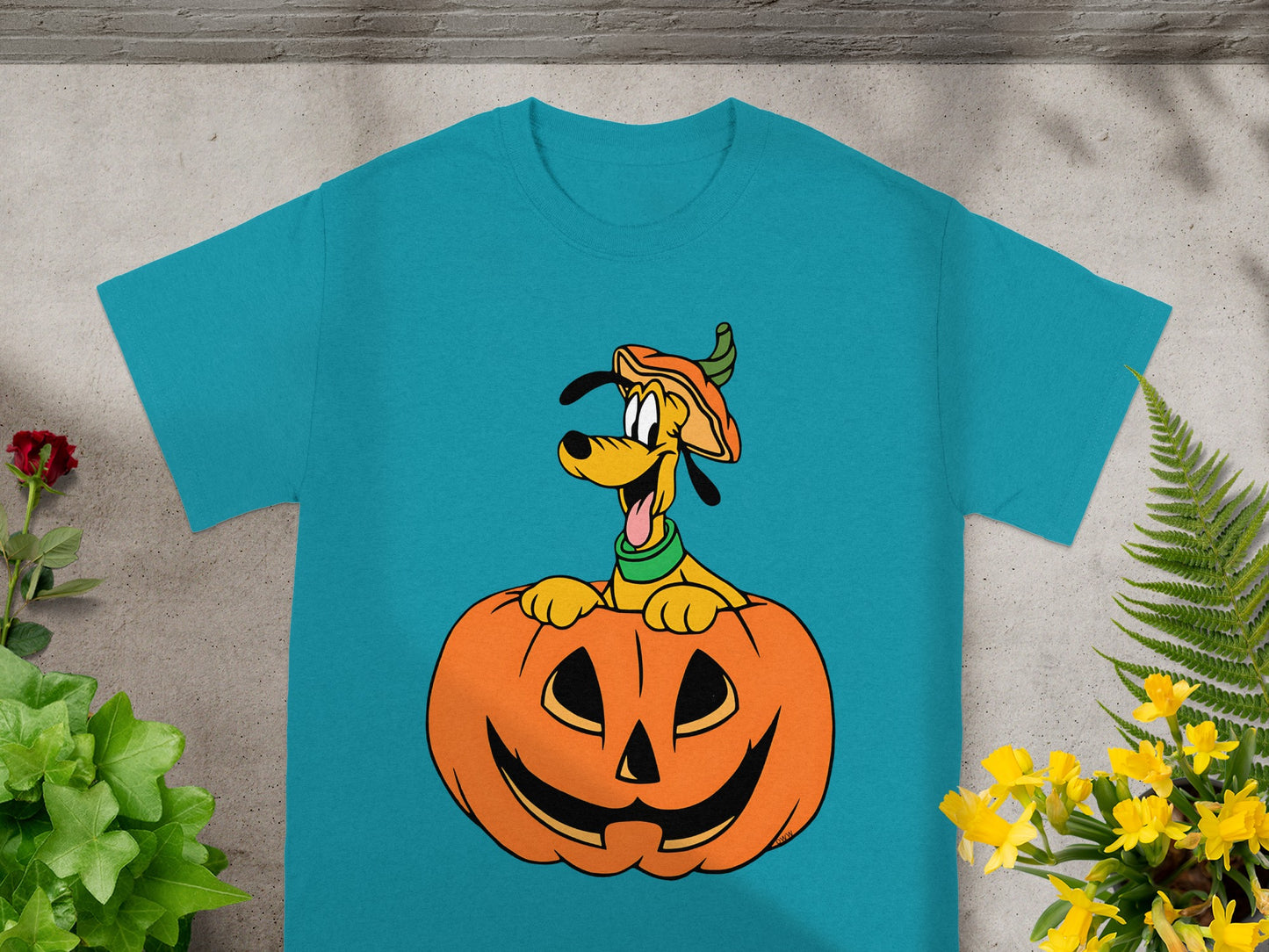 Teal t-shirt featuring Disney's Pluto peeking out of a jack-o'-lantern.