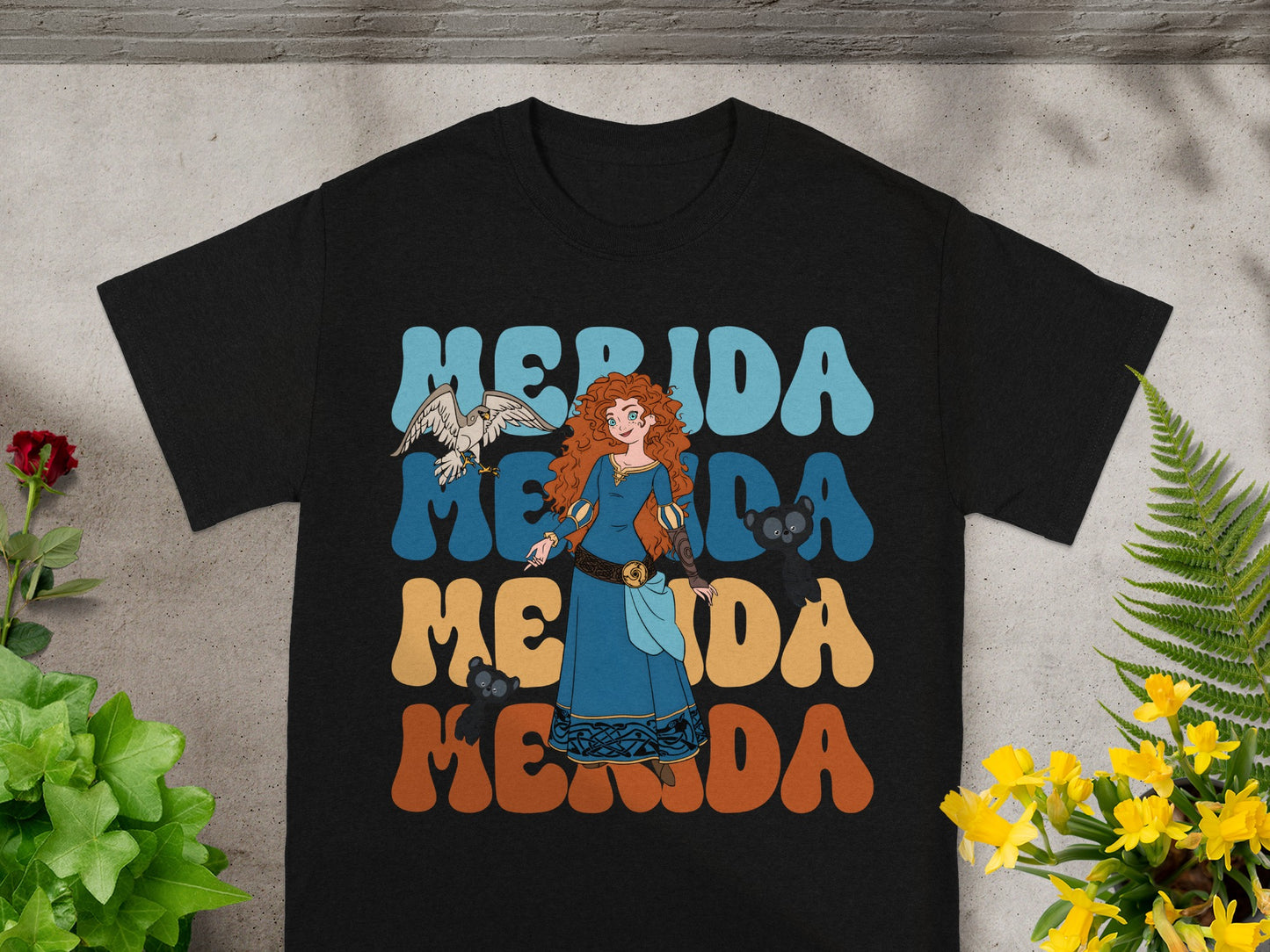 Black t-shirt with "Merida" in retro font and a depiction of Merida with a bird.