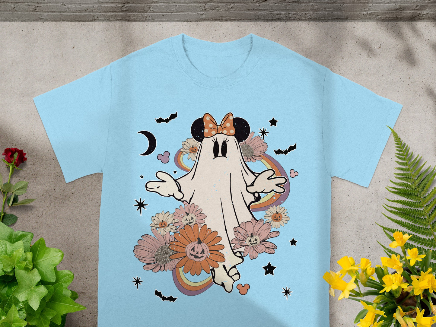 Light blue t-shirt with a retro ghost, flowers, pumpkins, and bats design.