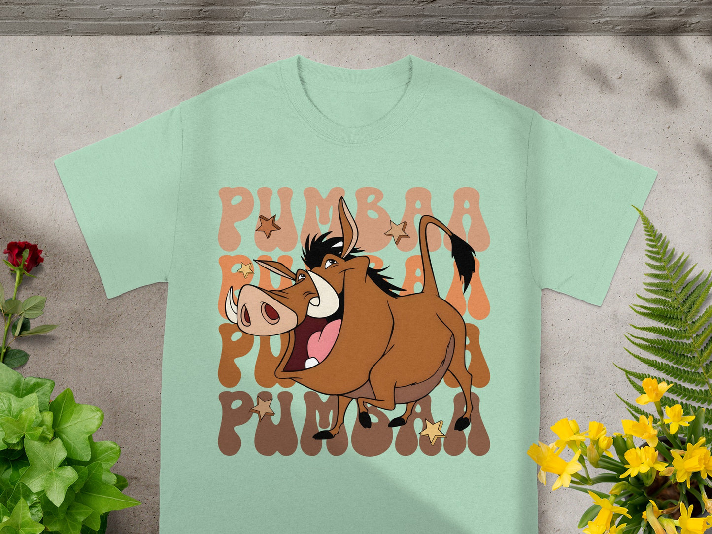 Pumbaa from The Lion King on a light mint green t-shirt.