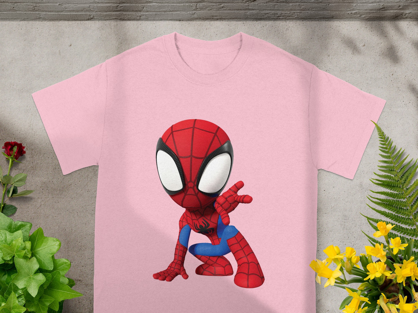 Pink t-shirt with a cartoon Spider-Man graphic in a crouching pose.