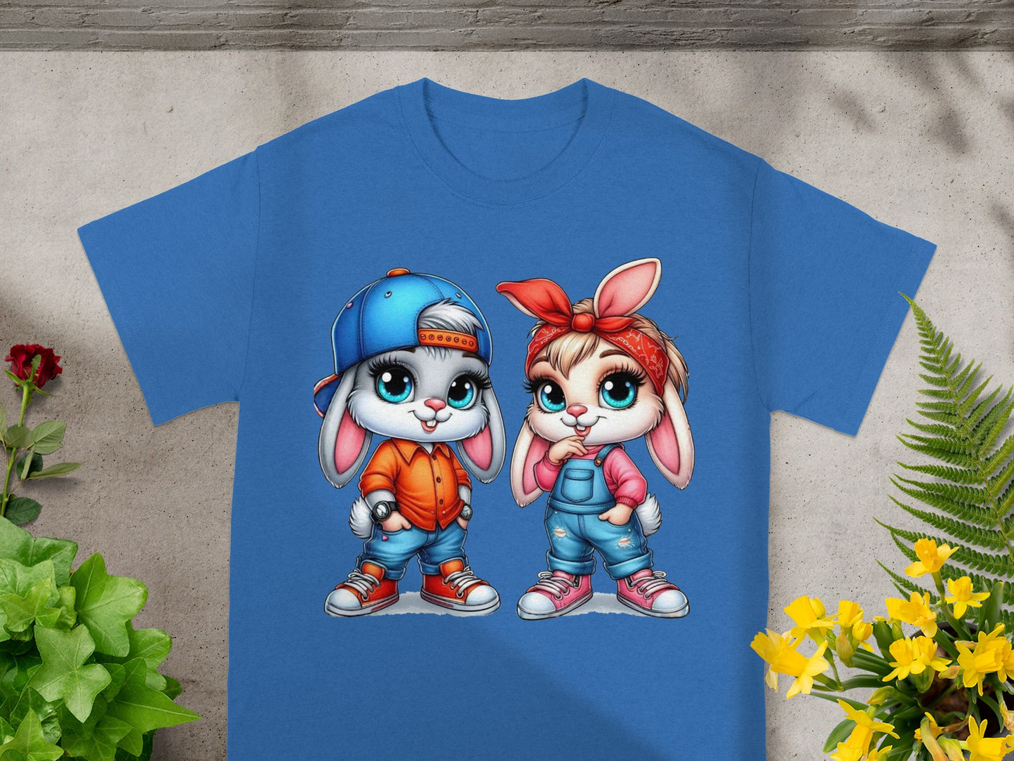 Blue t-shirt with cartoon boy and girl bunnies in denim overalls.