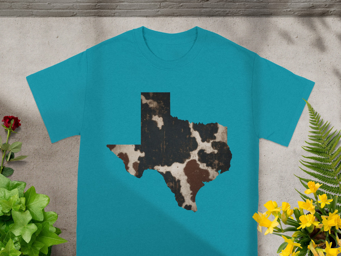 Teal t-shirt with a distressed cowhide-patterned Texas state outline.