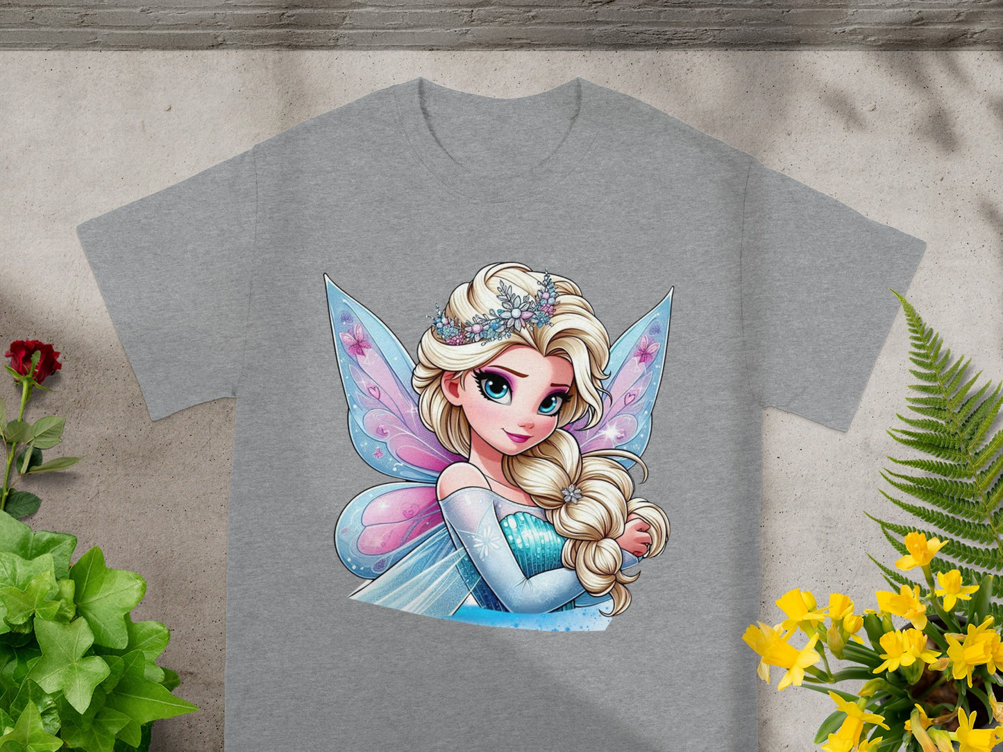 Grey t-shirt featuring illustration of a blue-eyed fairy with blonde hair, wearing a crown and sparkly dress.