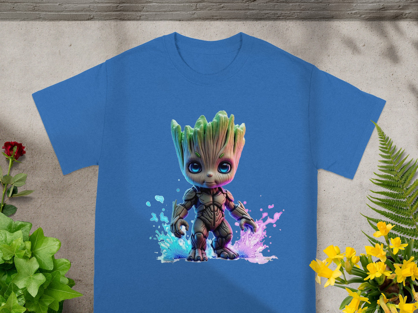 Blue t-shirt with a watercolor Groot graphic and pink and blue splatters.