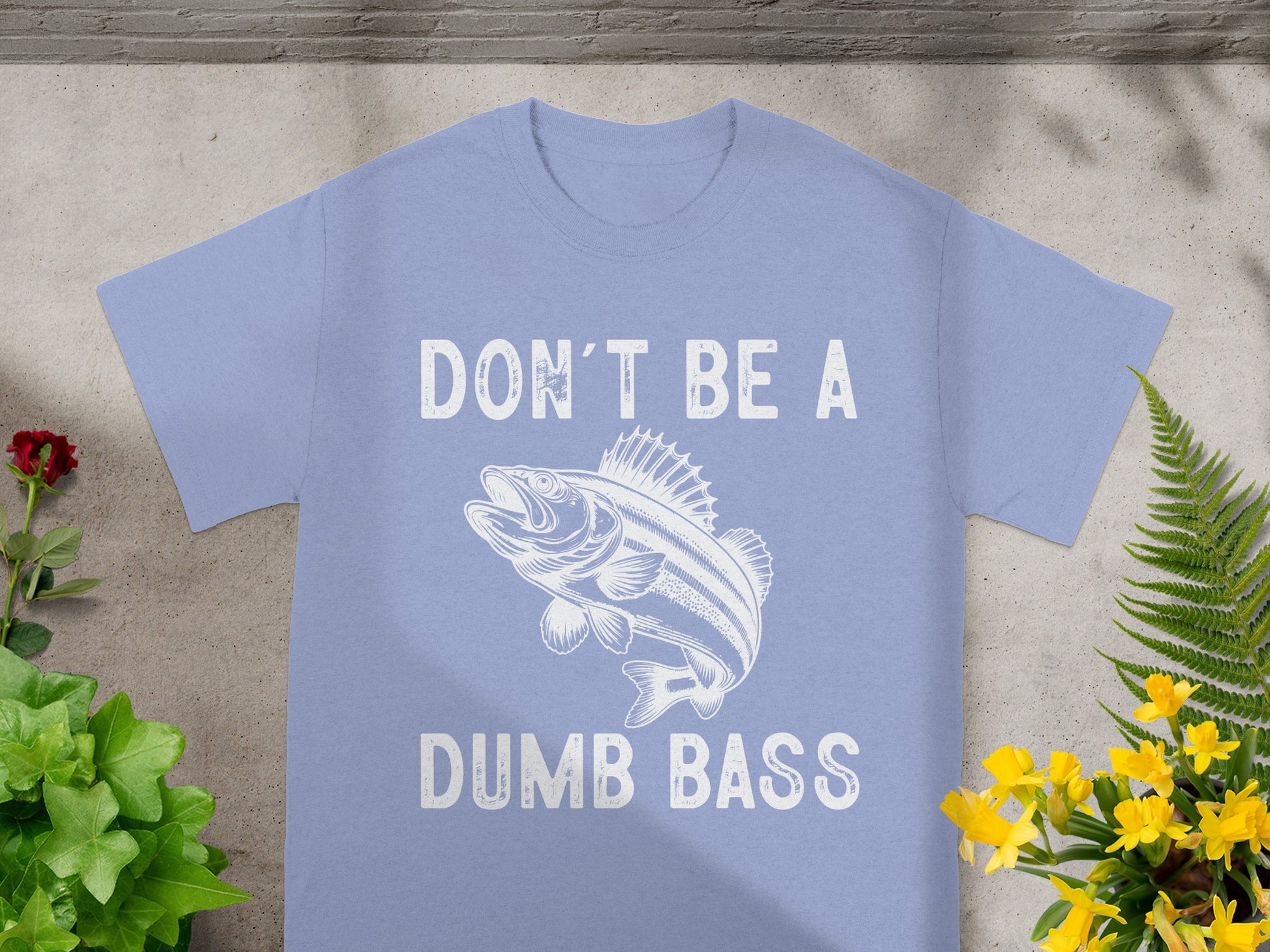 Light blue t-shirt with white text "DON'T BE A" above a fish illustration.